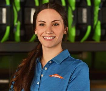 SERVPRO employee in blue polo posing for crew photo.