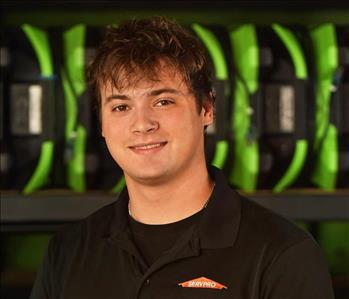 SERVPRO employee in black polo posing for crew photo.