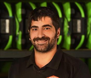 SERVPRO employee in black polo posing for crew photo.