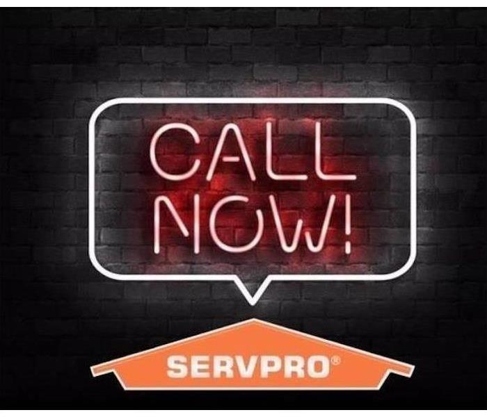 black background with neon SERVPRO sign 