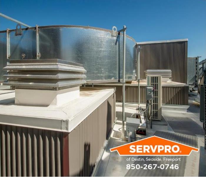 The HVAC system of a commercial building is shown on top of a building.