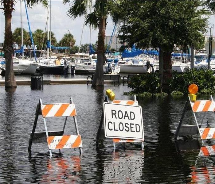 Flooded street and Road Closed Sign 